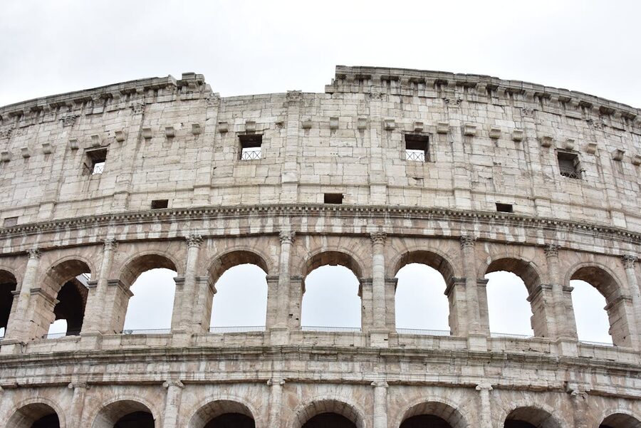 Architectural view of the Colosseum showing its iconic arched exterior facade