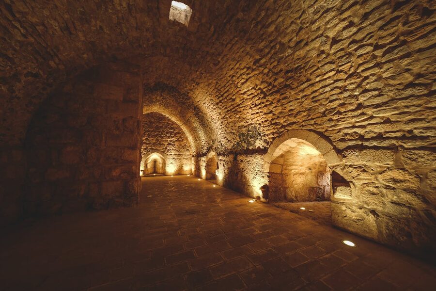 Mysterious stone tunnel passageway illuminated by soft warm ambient lighting