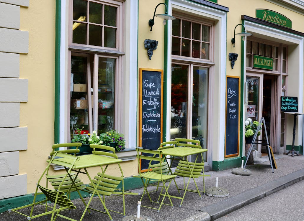 Austrian cafe with green outdoor seating on a city street