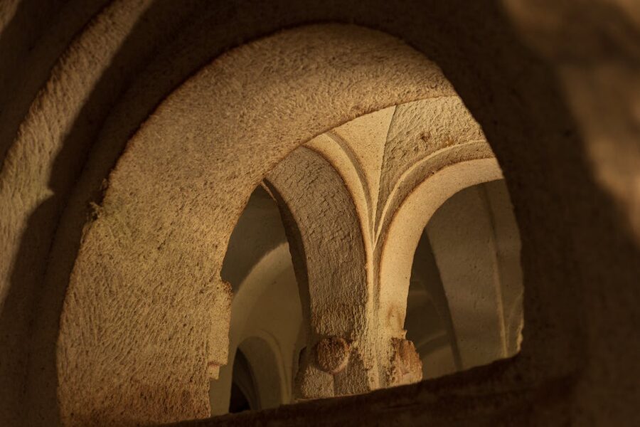 Close-up of ancient stone archways and decorative carved details illuminated by warm light