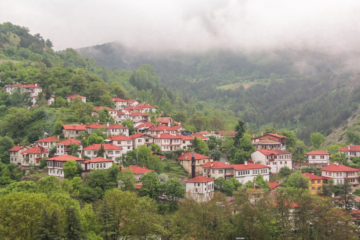 Picturesque Greek mountain village with red roofs and misty mountains