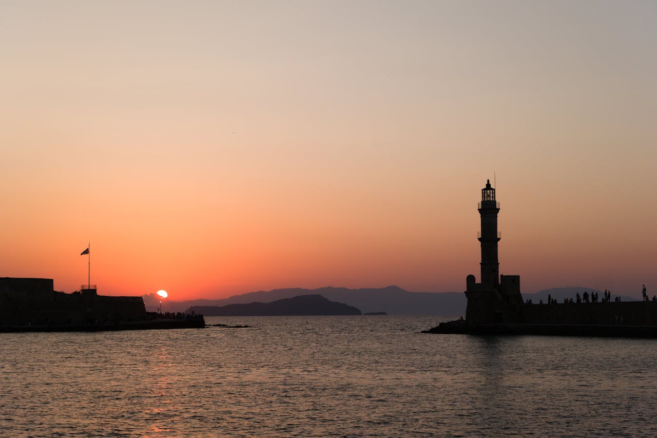 Beautiful sunset view of Chania lighthouse captured from the harbor in Crete Greece
