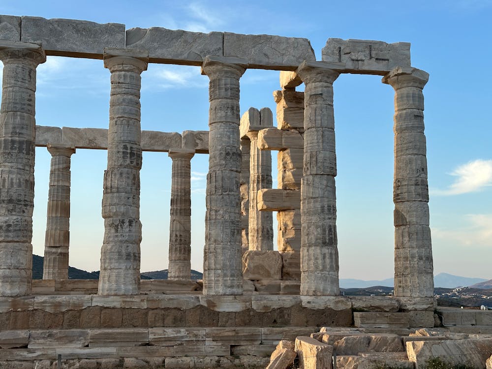Temple of Poseidon in Sounion illuminated by warm sunset light
