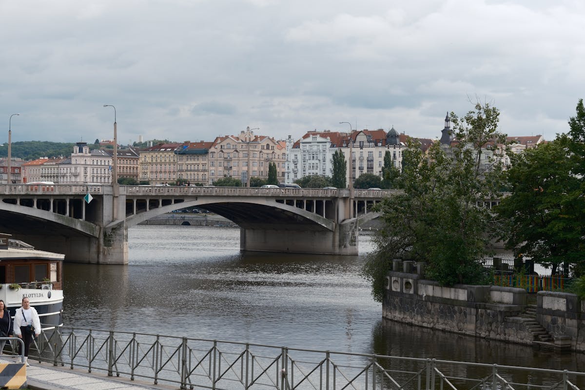 Vltava River and historic Prague architecture from a riverside promenade in spring