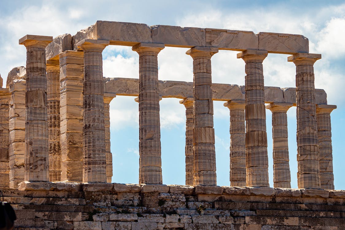 The iconic Temple of Poseidon perched on the cliff at Cape Sounion Greece