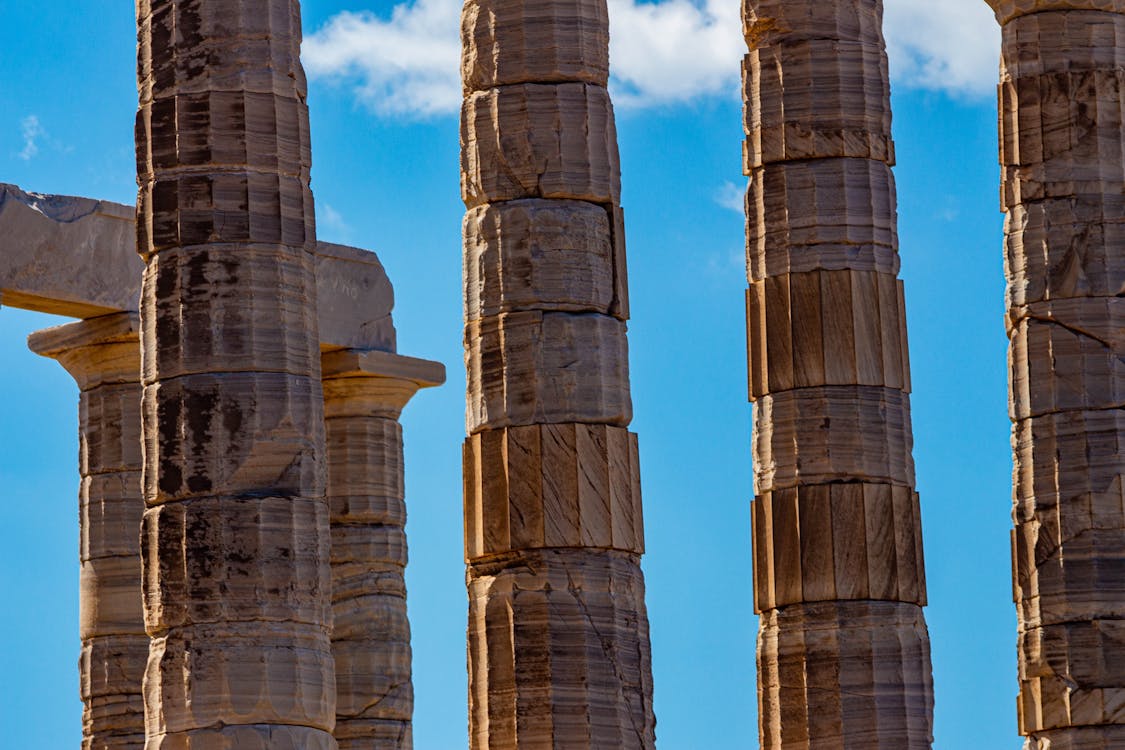 Close-up of ancient temple columns at the Temple of Poseidon under blue sky