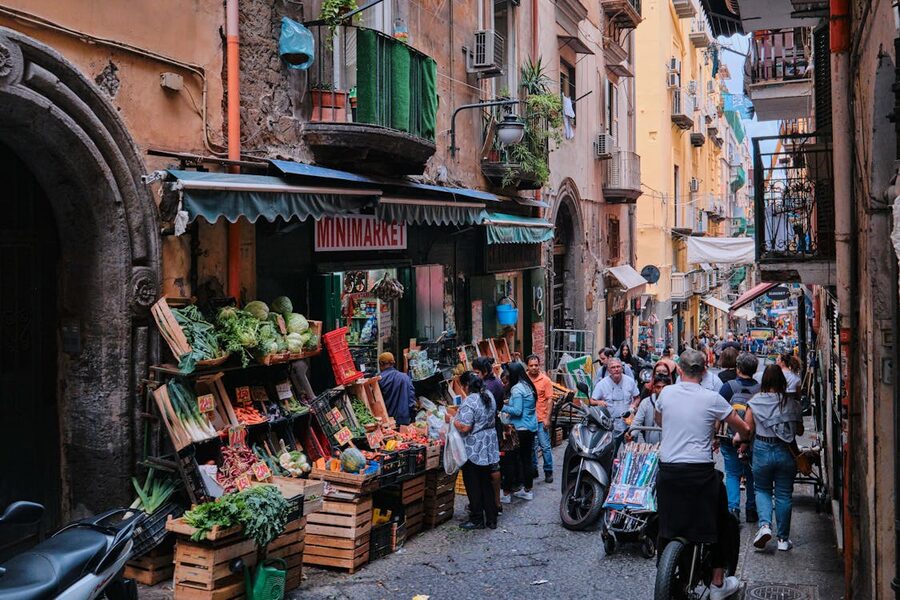 Street market in Naples Italy with fresh produce stalls and traditional architecture