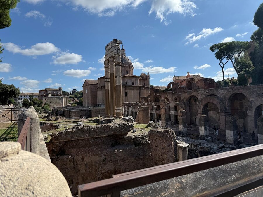 Ancient ruins of the Roman Forum under daylight showing stone structures and columns