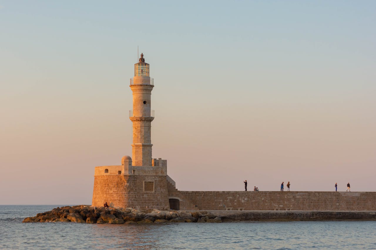 The Chania Lighthouse standing elegantly against a warm evening sky in Crete Greece
