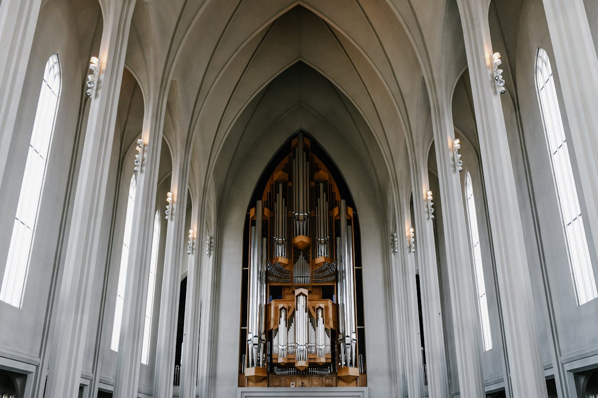 Interior of Hallgrimskirkja church with white arches and organ in Reykjavik