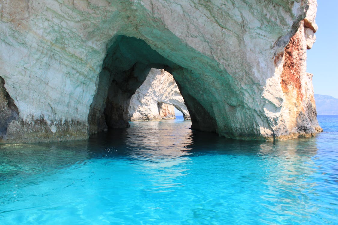 Natural rock arches of the Blue Caves in Zakynthos with crystal clear blue water
