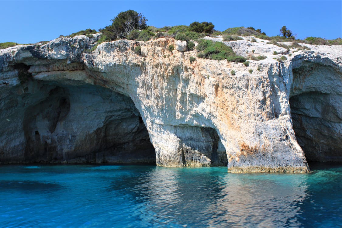 Crystal clear turquoise water inside the Blue Caves of Zakynthos with white rock formations