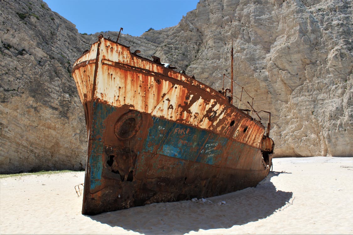 Close view of the rusted bow of the MV Panagiotis shipwreck on white sand at Navagio Beach