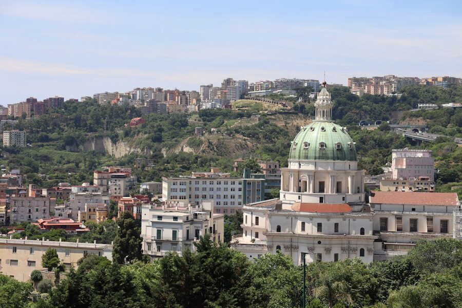 Panoramic view of Naples cityscape with prominent church dome rising above the rooftops