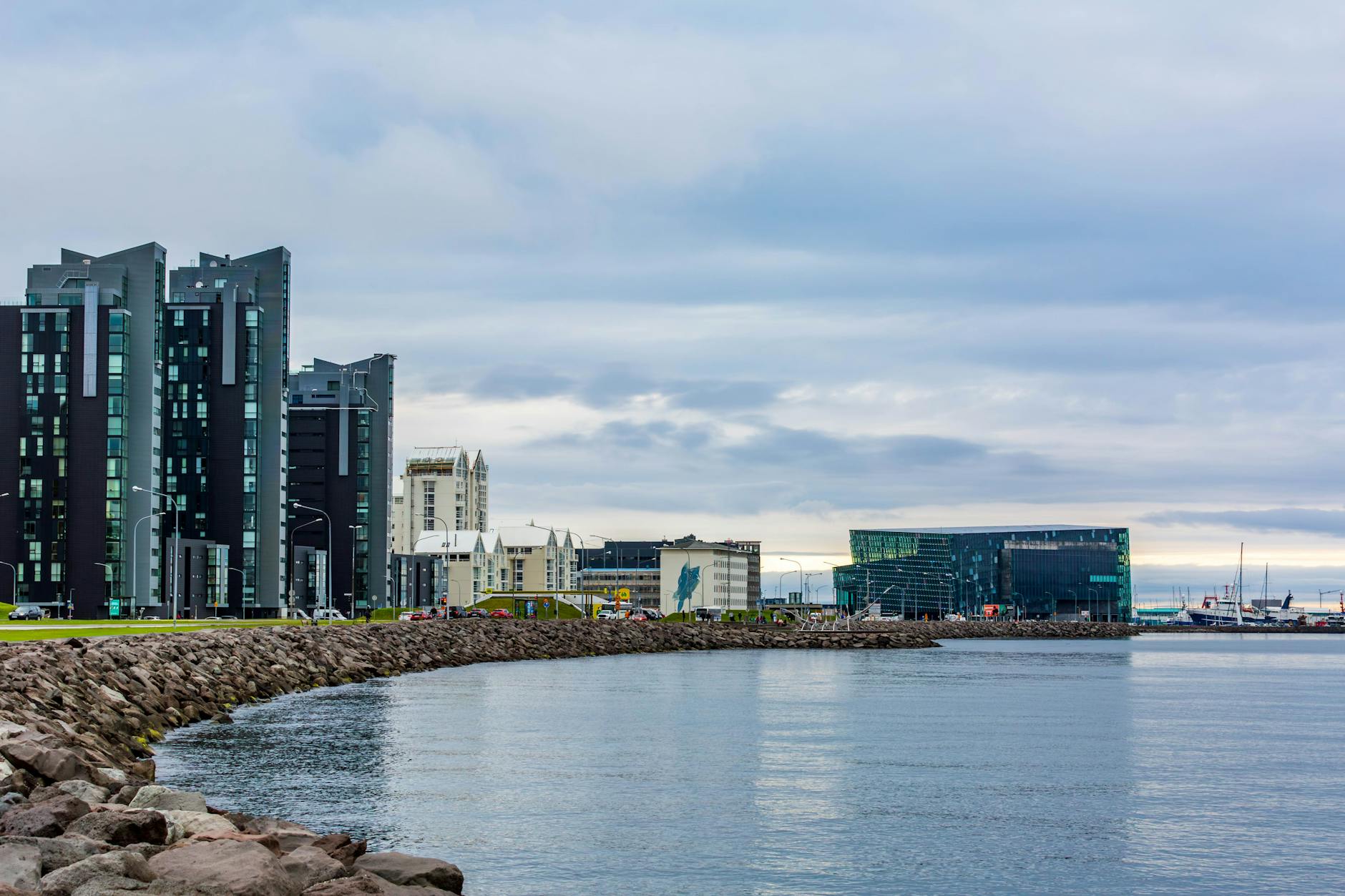 Reykjavik harbor area on a clear day with boats and mountains