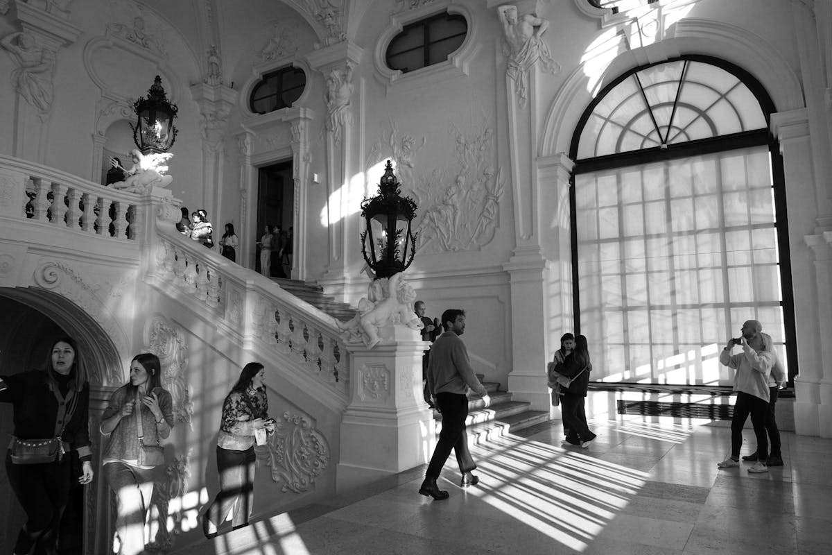 Visitors in a grand baroque interior hall in Vienna Austria