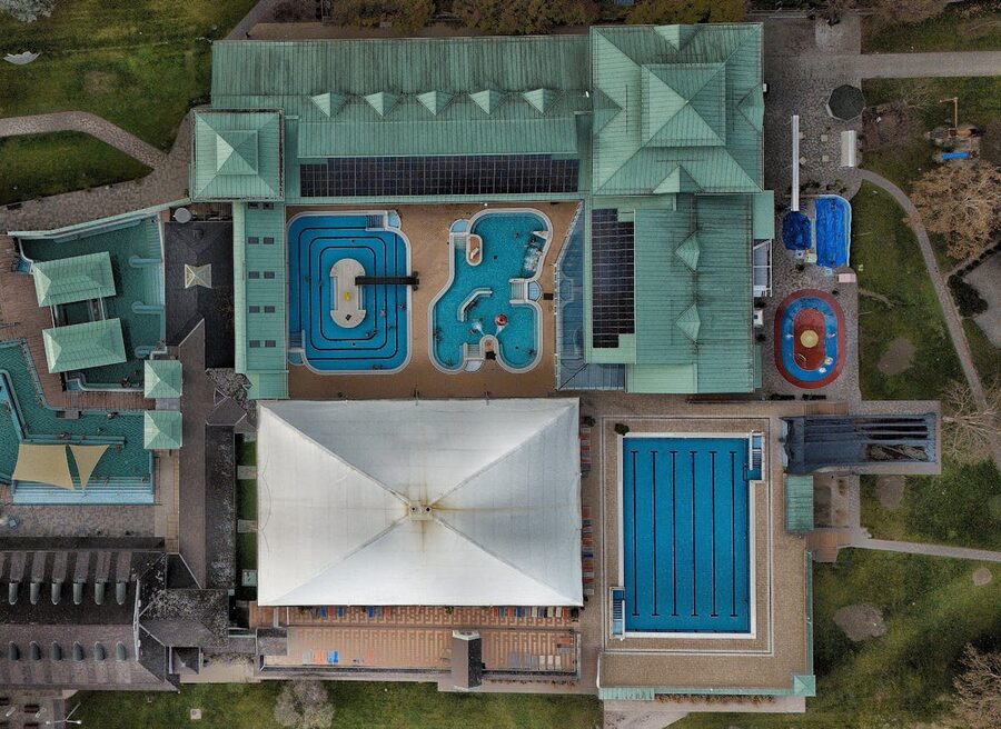 Steam rising from thermal pool with swimmers at Szechenyi Baths on a cold day