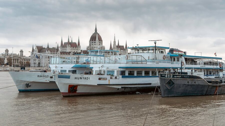Tourist boats anchored on the Danube River with the Hungarian Parliament Building in Budapest