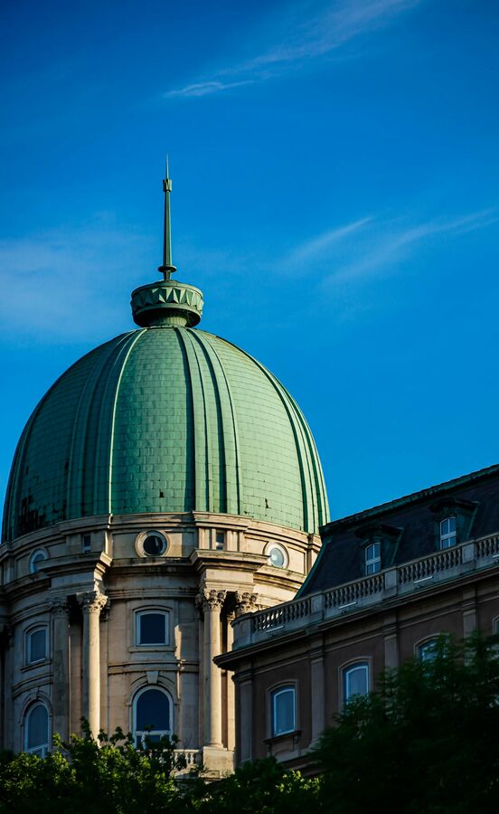 Dome of Buda Castle against a clear blue sky in Budapest