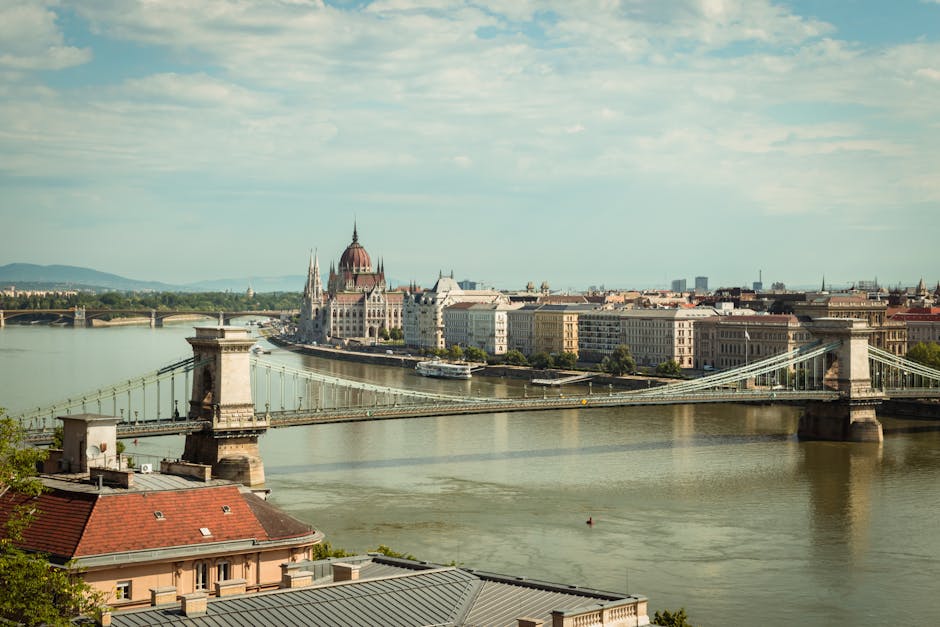 Panoramic daytime view of Szechenyi Chain Bridge and Hungarian Parliament Building across the Danube in Budapest