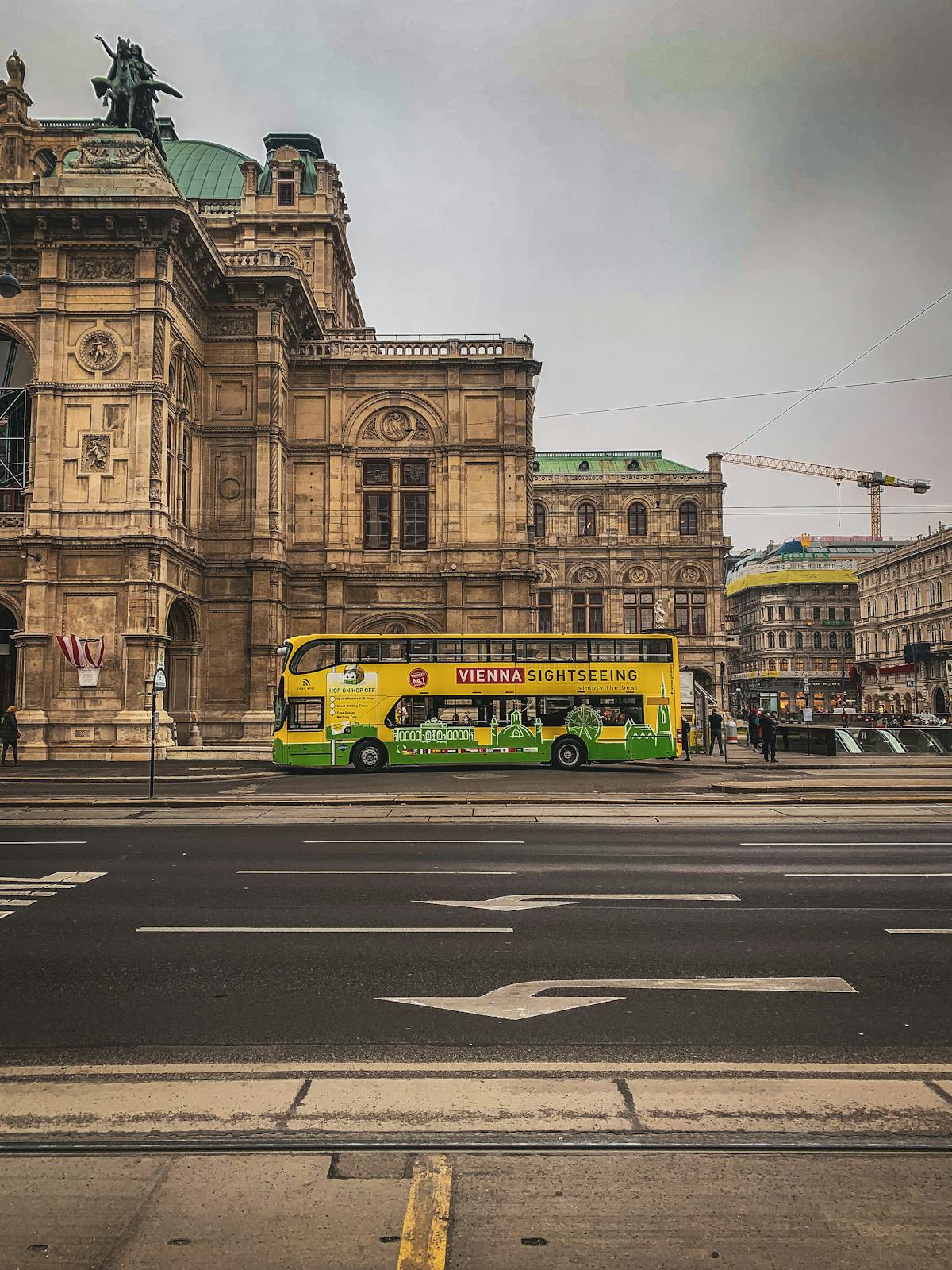 Sightseeing bus parked near the Vienna State Opera House
