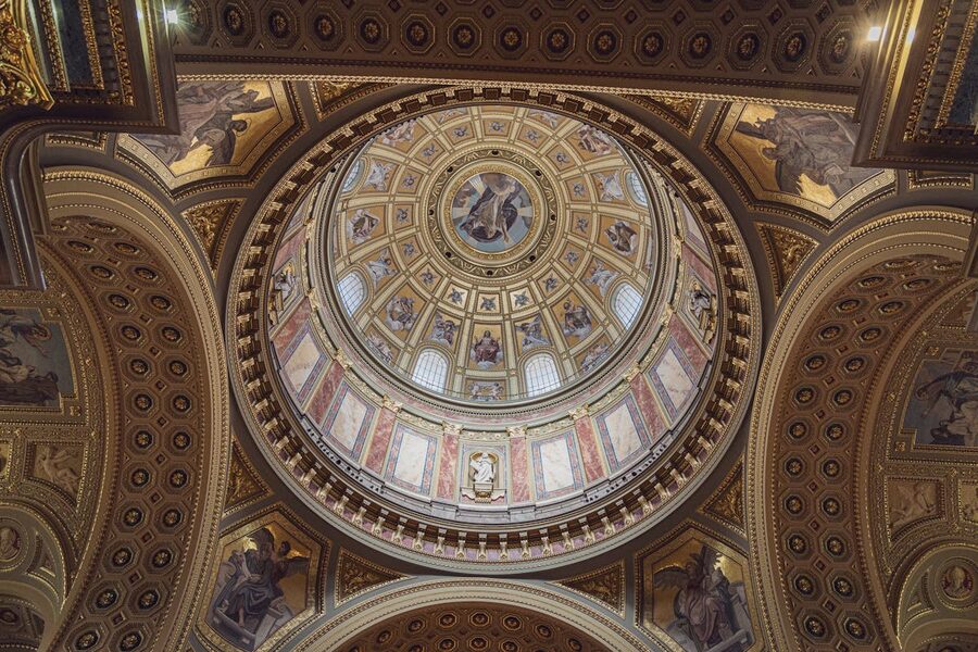 Ornate interior ceiling frescoes and gilded decorations inside St. Stephen's Basilica
