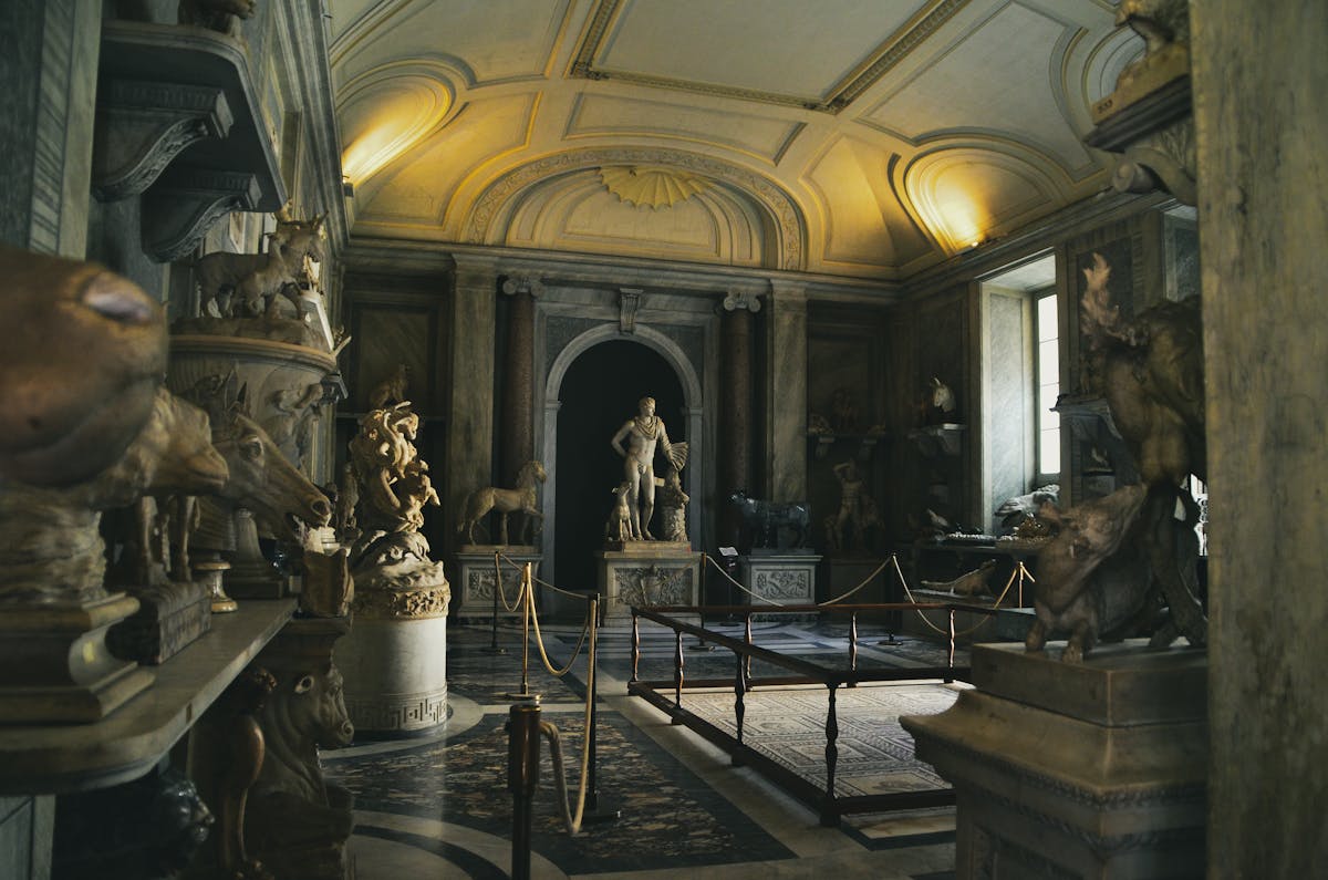 Classical Roman sculpture gallery with statues and elegant arched architecture