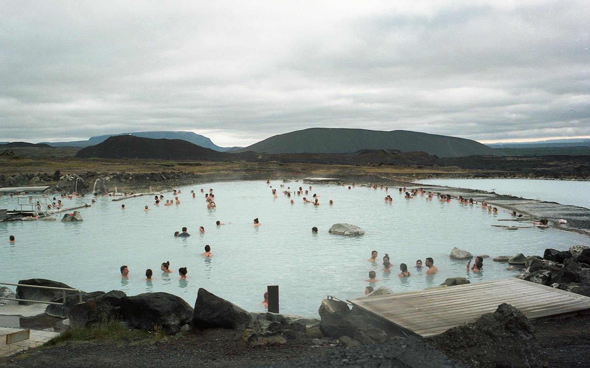 Visitors relaxing in a natural geothermal spa pool in Reykjavik Iceland