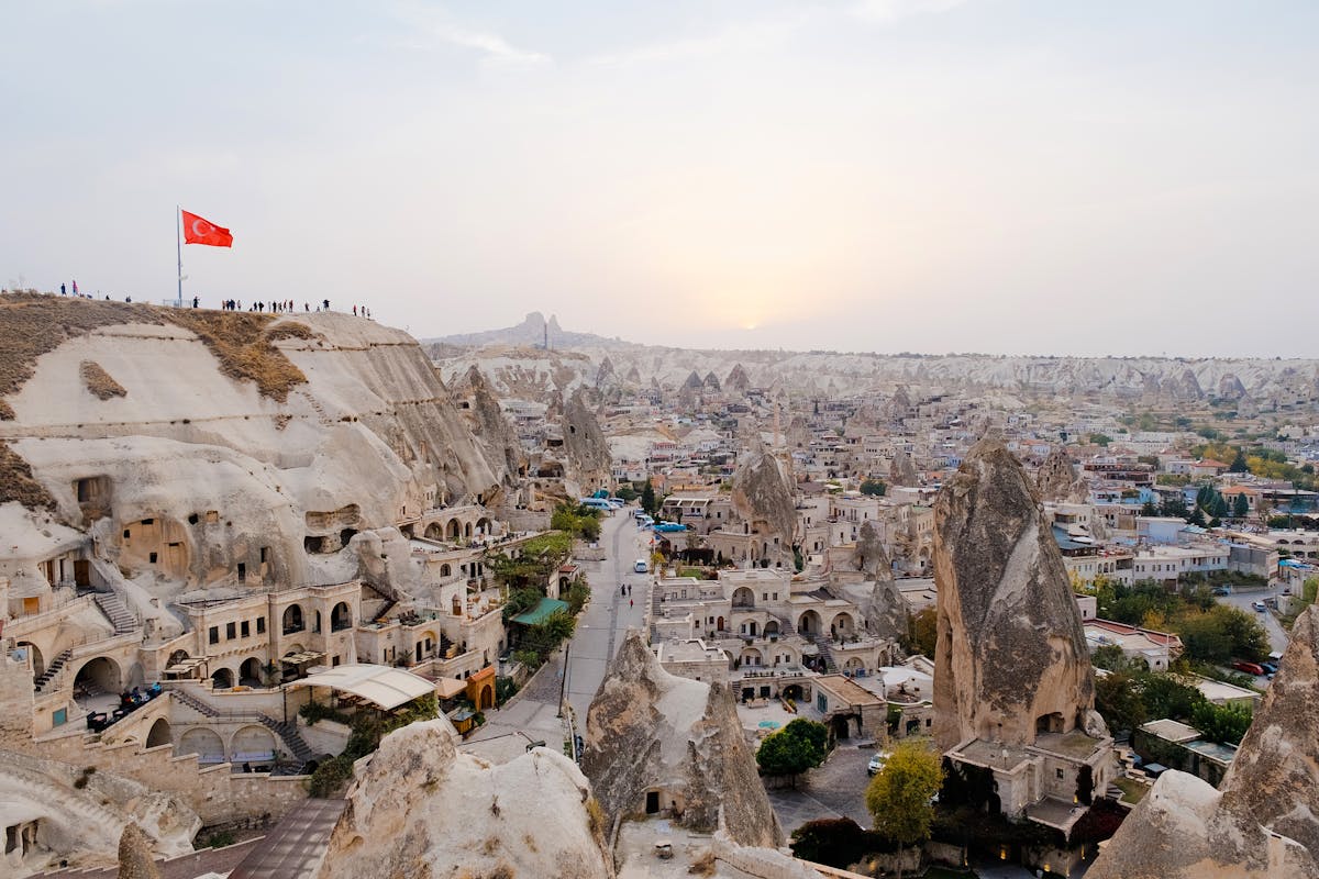 View of Goreme town with cave dwellings and rock formations at sunrise in Cappadocia