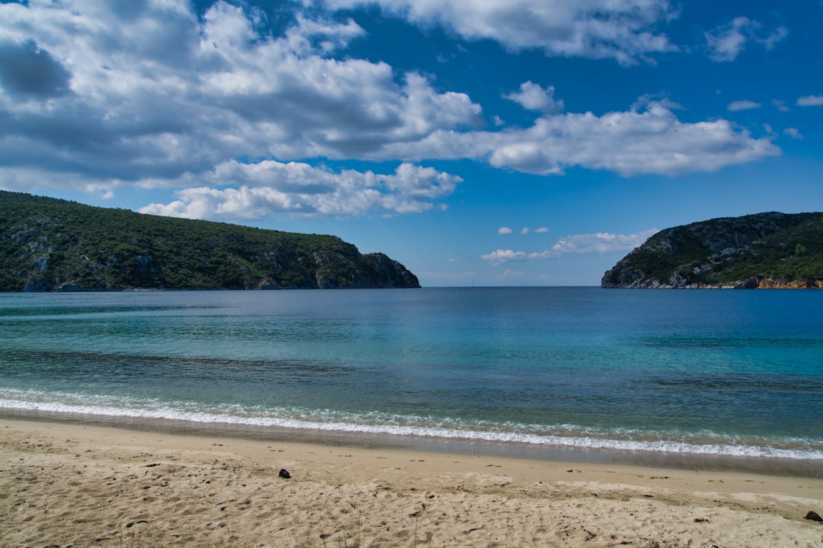 A turquoise beach with clear shallow water on a Greek island