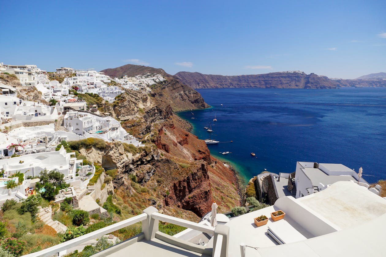 Sunset over white cliffside buildings in the Greek islands
