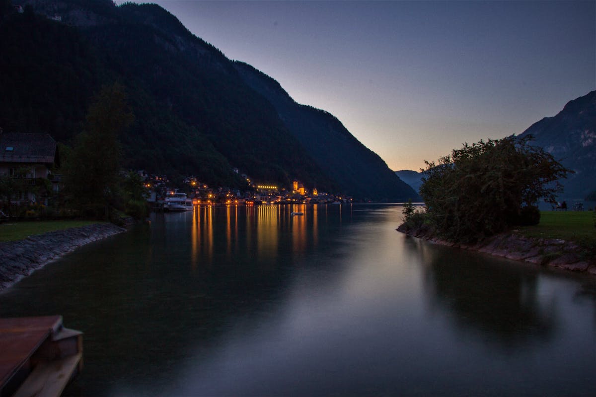 Hallstatt village at night with lights reflecting in the lake
