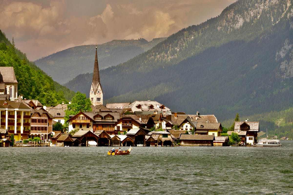 Hallstatt village reflected in the lake with mountains behind
