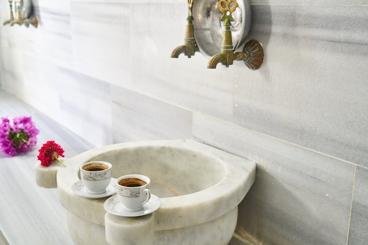 Interior of a traditional Turkish hamam with marble wash basins