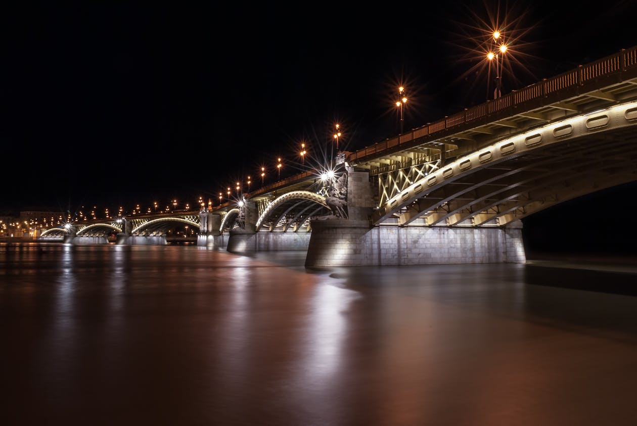 Margaret Bridge lit up at night over the Danube River in Budapest Hungary