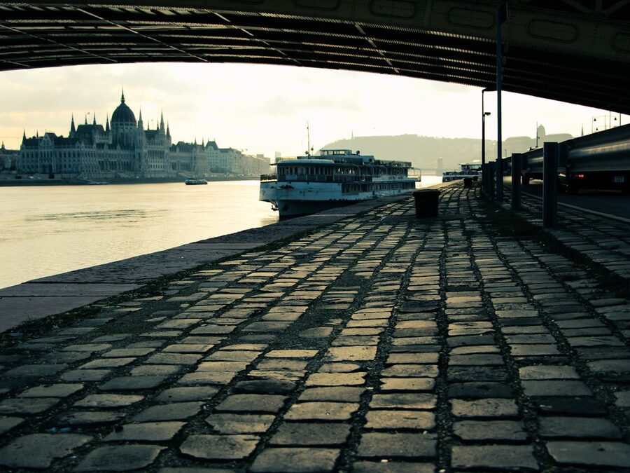 Hungarian Parliament Building at dawn with boats on the Danube River in Budapest