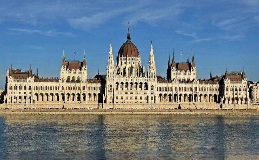 Hungarian Parliament on a sunny day by the Danube River in Budapest