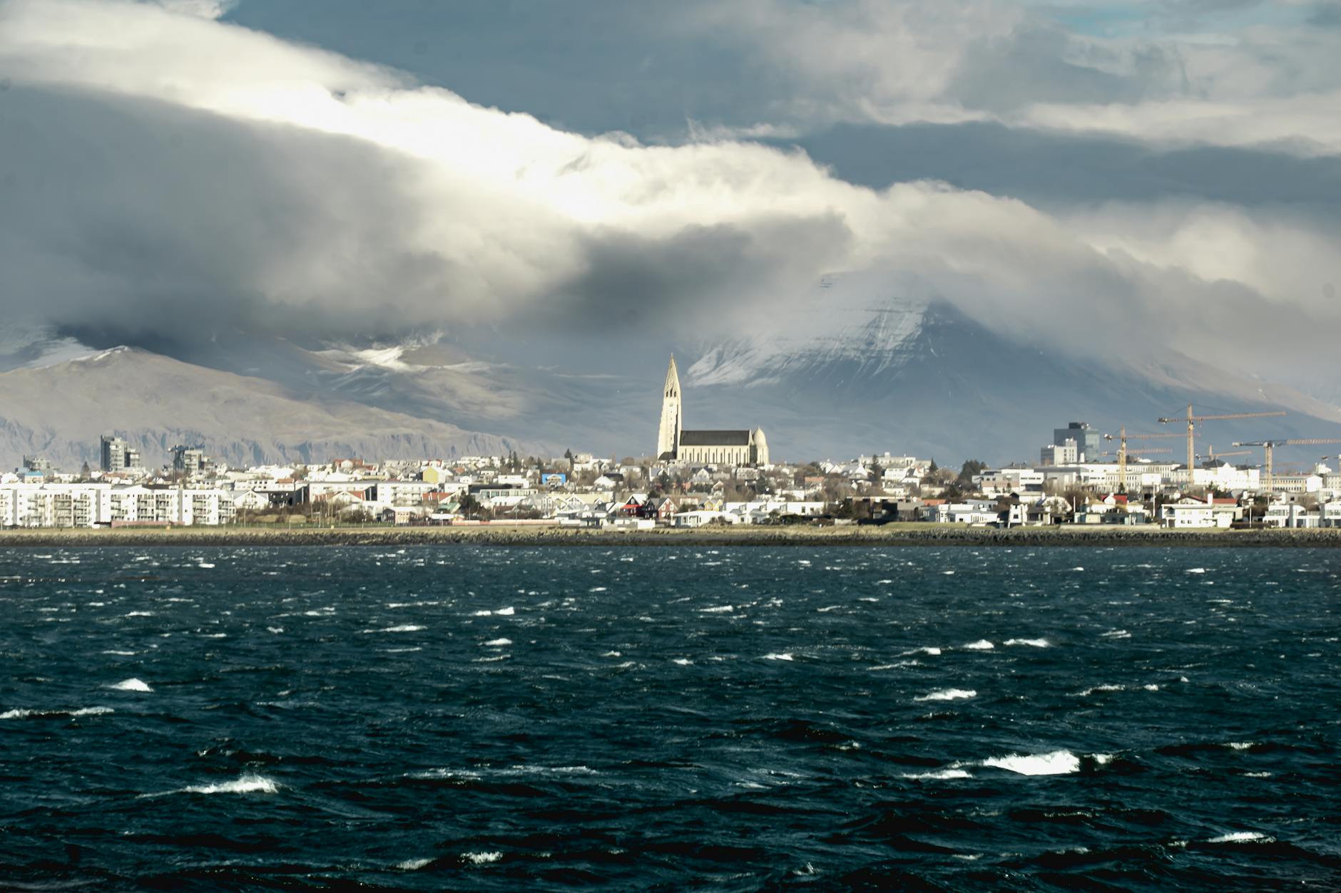 Panoramic view of Reykjavik skyline featuring Hallgrimskirkja church and ocean