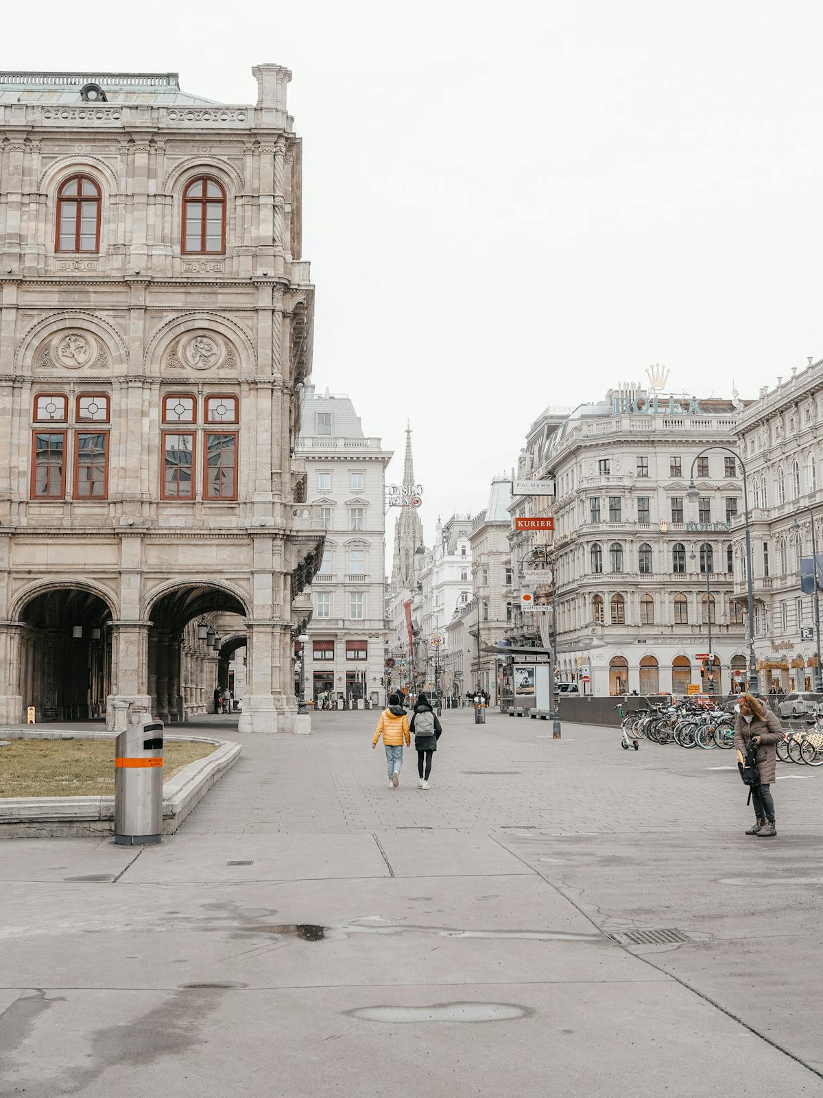 People walking along Vienna's Ringstrasse with elegant historic buildings