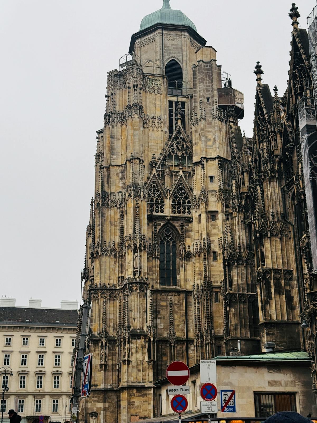 Gothic spire of St. Stephen's Cathedral in Vienna against a blue sky