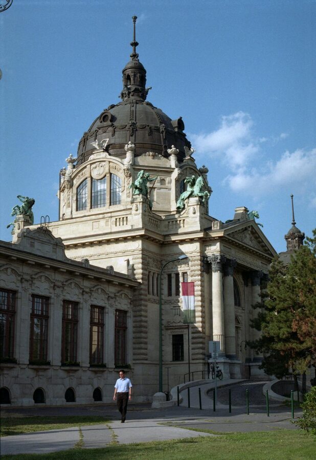 Outdoor thermal pools at Szechenyi Baths with steam rising in Budapest