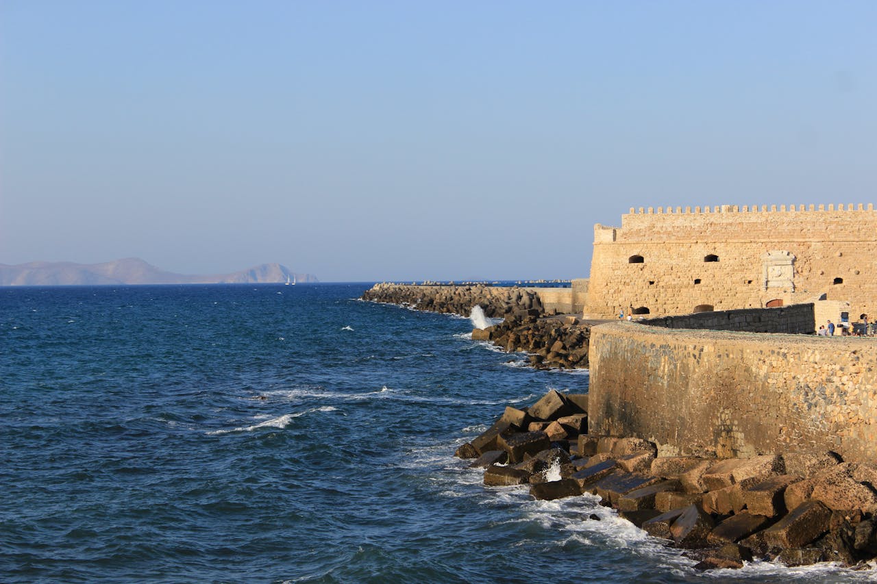 Venetian fortress walls standing against the waves of the Cretan Sea