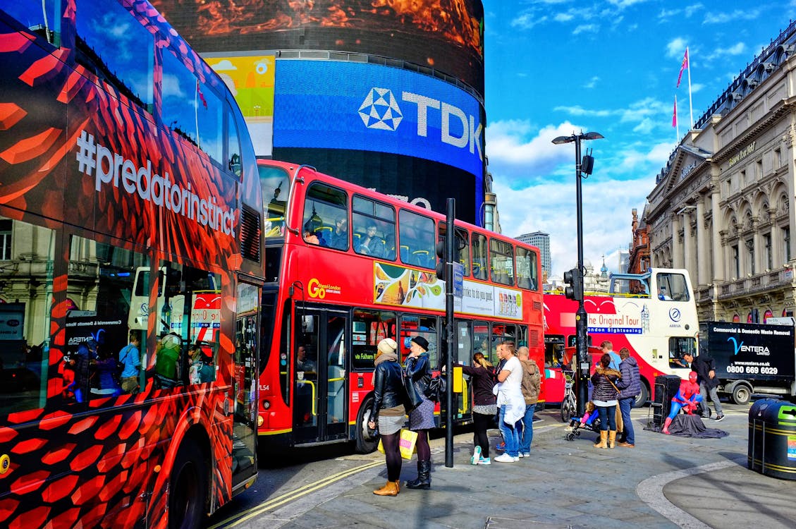 Colorful scene of double-decker buses and pedestrians at Piccadilly Circus in London