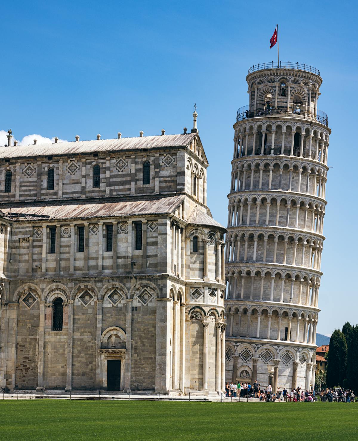 The Leaning Tower of Pisa alongside Pisa Cathedral showing Romanesque architectural details