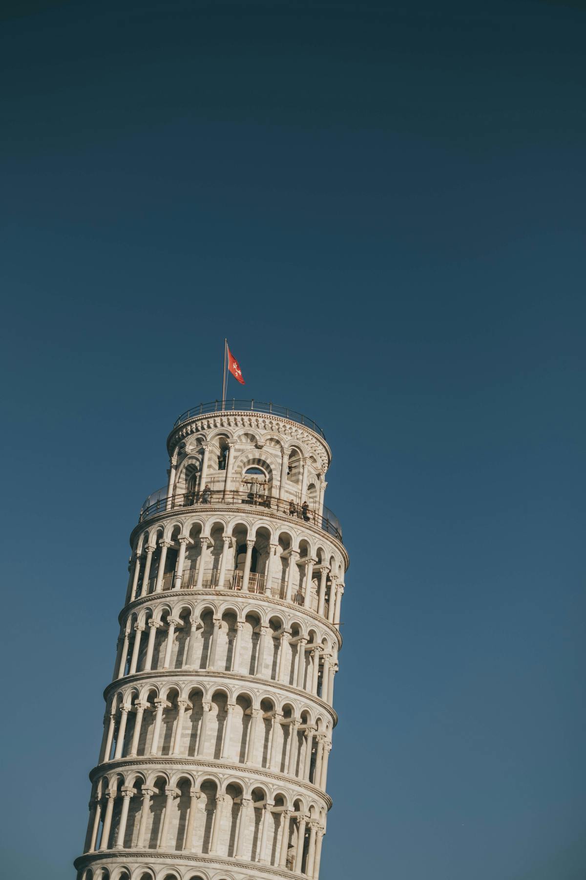 The Leaning Tower of Pisa tilting against a clear sky