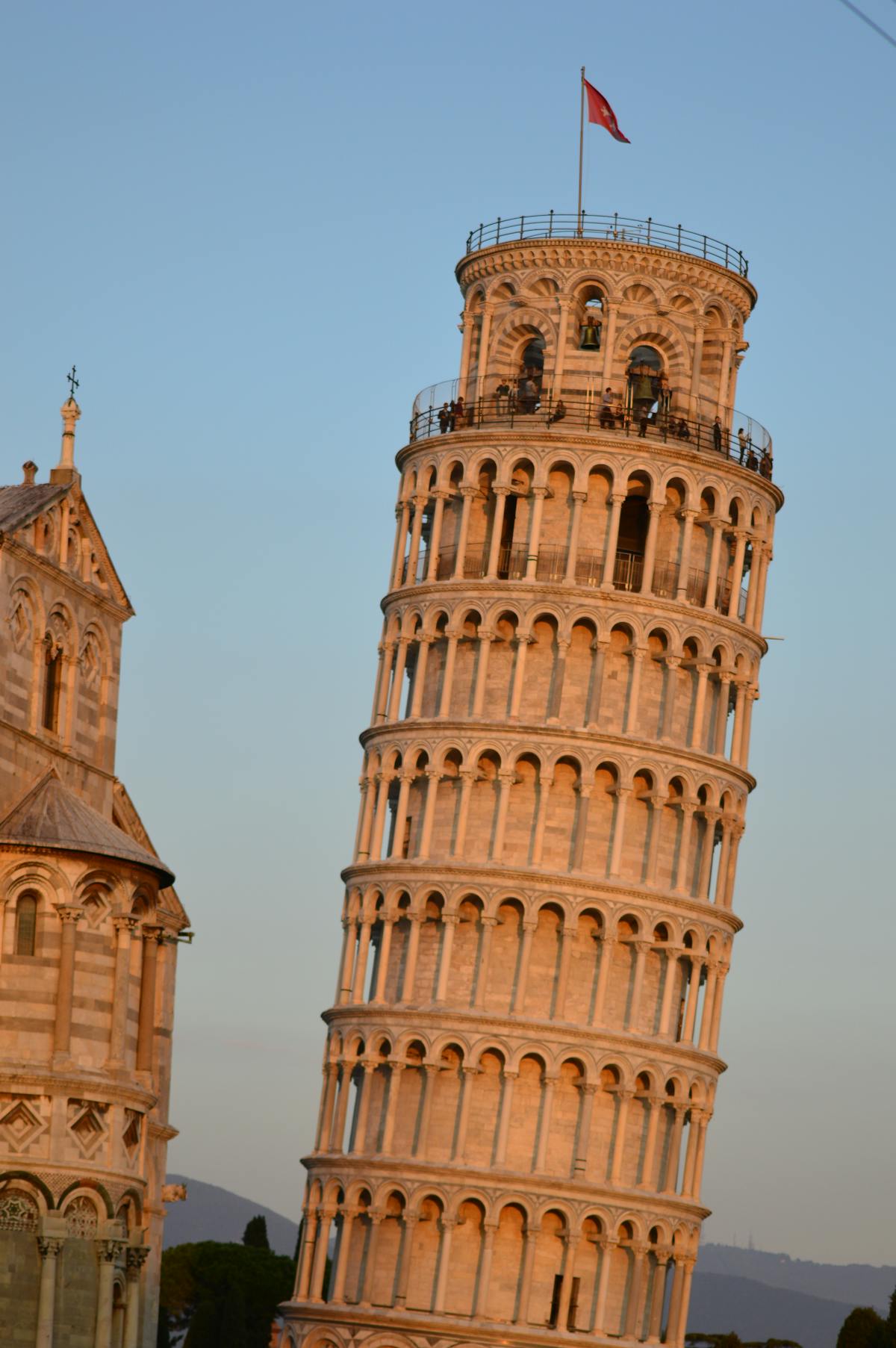 The Leaning Tower of Pisa bathed in warm sunset light