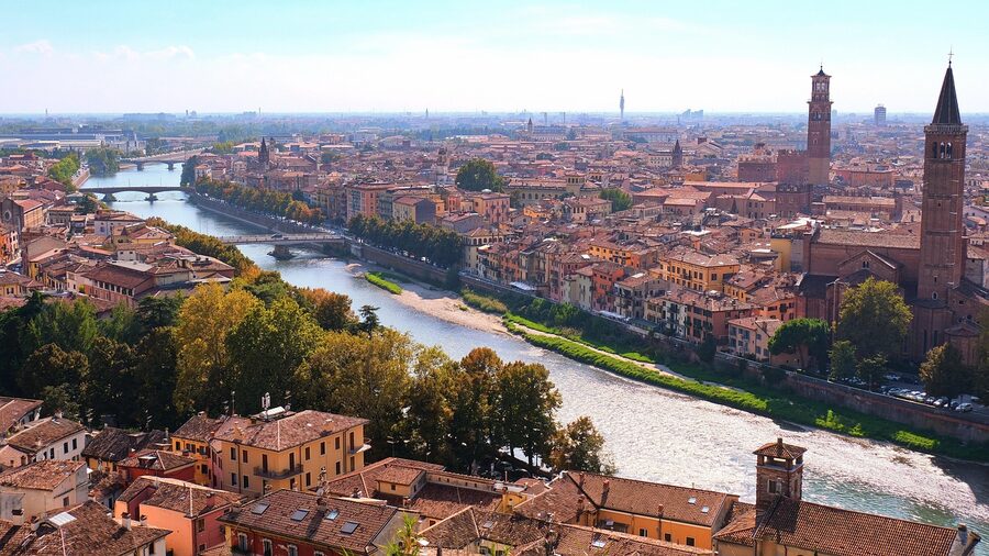 Panoramic view of Verona with a stone bridge over the Adige River and church towers