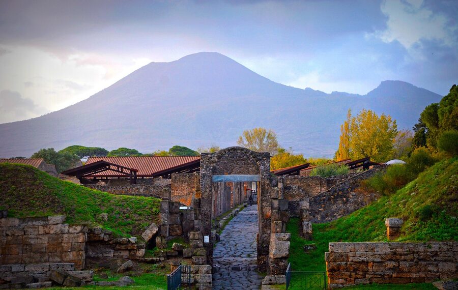 Mount Vesuvius volcano looming over the archaeological ruins of Pompeii Italy