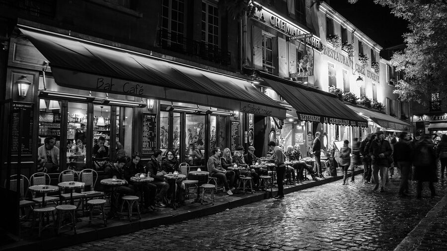 Montmartre neighborhood in Paris at night with warm lights and charming streets
