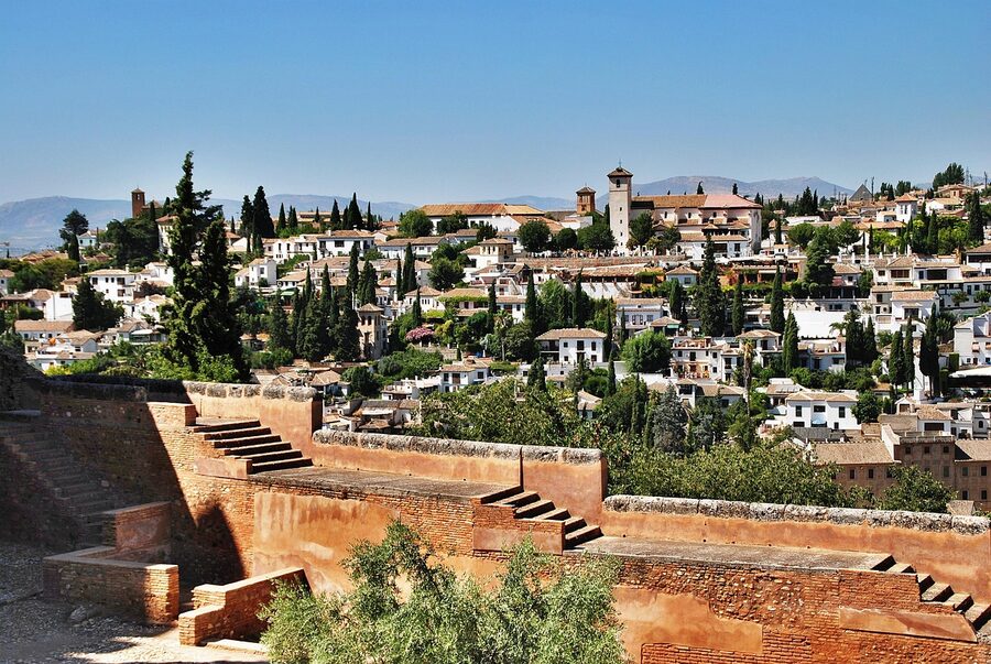 Panoramic view of Granada with historic buildings spreading across green hills